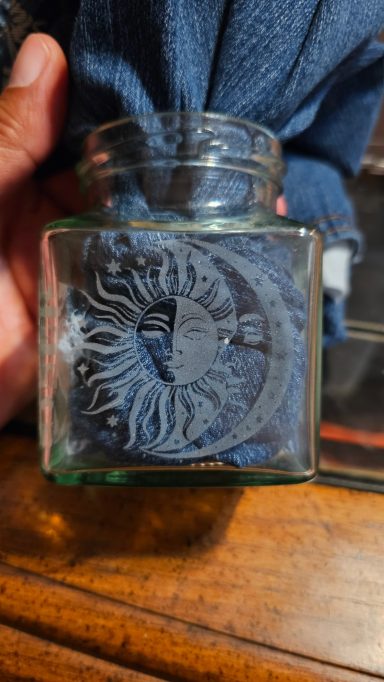 jar with sun and moon image on one side